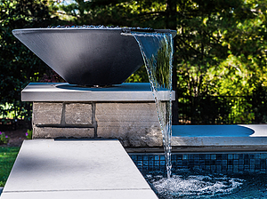 St. Louis custom designed geometric concrete pool with cut stone coping and stone column with water fire bowl