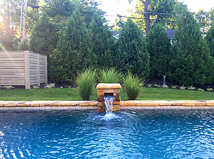 St. Louis custom designed geometric pool with flagstone coping and stone column with scupper