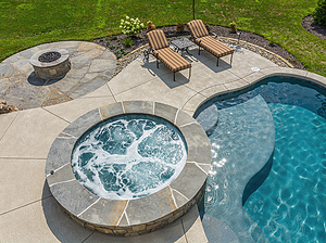 st. louis custom designed freeform concrete pool, raised concrete spa with flagstone cap