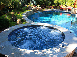 st. louis custom designed freeform concrete pool, raised concrete spa with flagstone cap