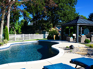 st. louis custom designed freeform concrete pool, black gazebo structure with seating area