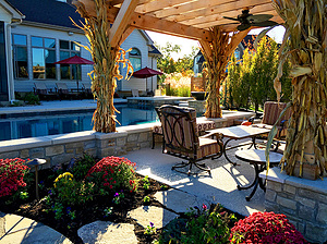 st. louis custom designed concrete pool, wood pergola with seating area, stepping stone pathway, colorful landscaping