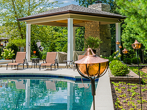 st. louis custom designed concrete pool, gazebo structure with stone fireplace, tiki torches